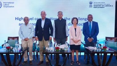 Panelists on the dais at a meeting