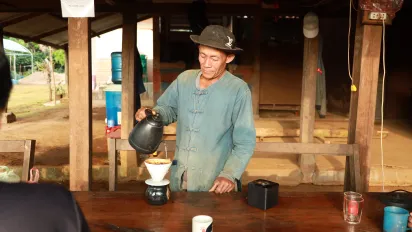 A man is making coffee.