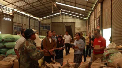 People standing in a coffee beans storage. 