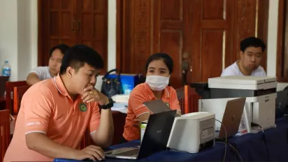 Officials provide social security services to people in rural Lao People's Democratic Republic.