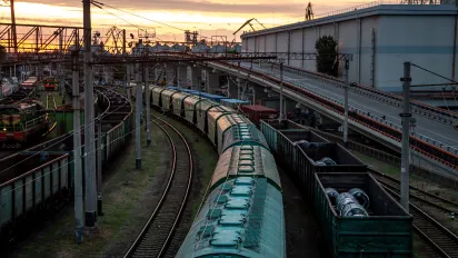 View from a railway bridge of freight trains in the sunset