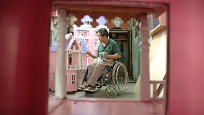 a disabled entrepreneur making pink toy houses
