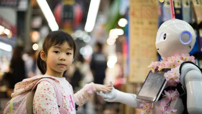 Young girl interacting with robot