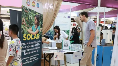A visitor is reading information about the ILO's booth.