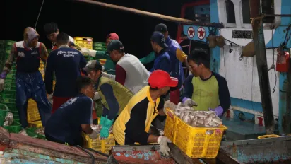 Fishers are doing their daily work in their working environment at Klidang Lor fishing port in Batang, Central Java, Indonesia.
