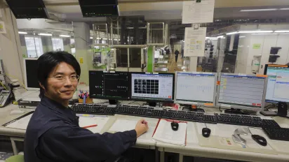 Technician in the computers room. Printing the Asahi Shimbun Newspaper evening edition. Kyoto Printing Factory. Kyoto, Japan.
