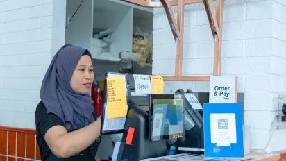 a cashier accepts digital payment using a QR code
