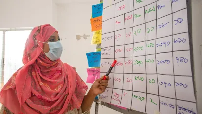 Akhter is writing on a board.