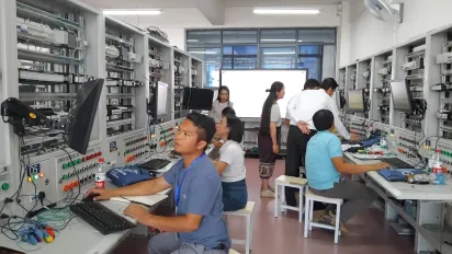 Women and men study electronics.
