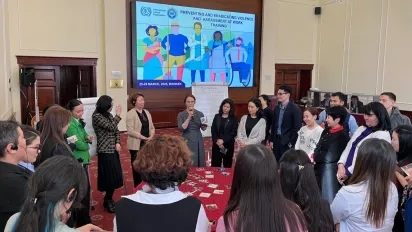 A group of people standing around a table