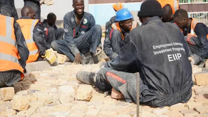 Students paving the fresh produce market with cobblestone in Turkana