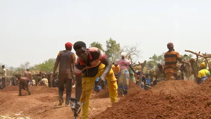 People working in a quarry under the sun