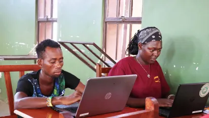Two students on laptops 