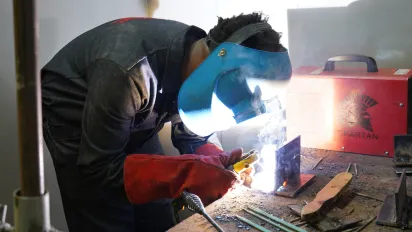 Student welding at the EAIW
