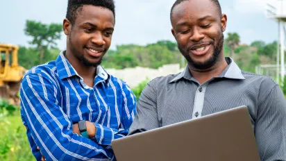 Two men looking at laptop