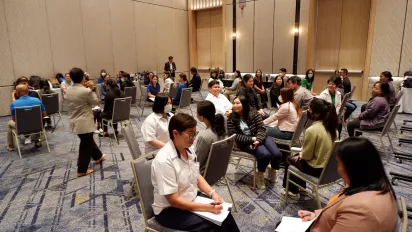 Men and women sit facing one another.