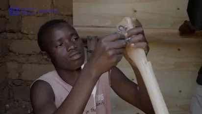 a young person tying the guitar chord