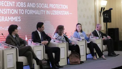 Five people sitting in chair facing the audience
