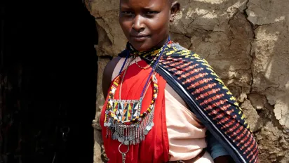 Maasai Woman near a Manyatta with a child