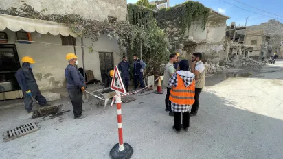 Workers on a street in Aleppo, Syria working in a cordened off section for road works