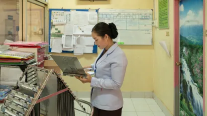 Nurse looks at a medical chart.
