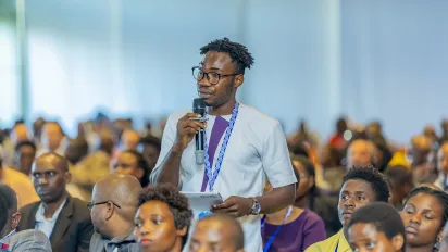 Seminar participant standing with a microphone to ask a question