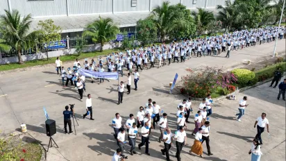 Aerial view of a group of workers walking across an economic zone