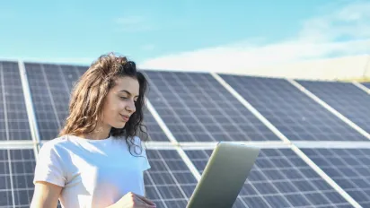 Young woman in front of solar panels