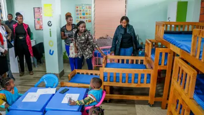 Wow Mom founder Peninnah showing her guests the day care facility at Mwariro Market 