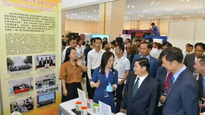 People gathering in front of a booth. 