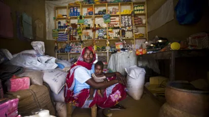 woman and a child sitting inside a shop