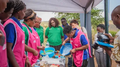 young people showing their products during donor visit in Uganda