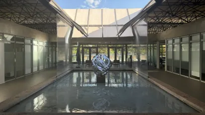 Vista do pátio interno do Escritório da OIT para o Brasil com espelho de água e escultura .
