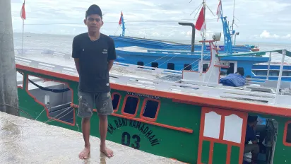 A young man standing on the port