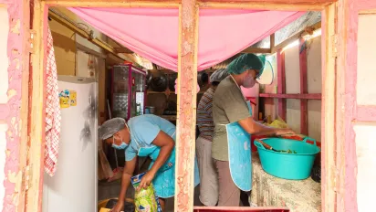 three SME workers in a small kitchen 