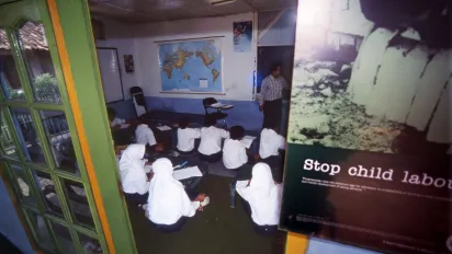 several students sitting inside a small class room