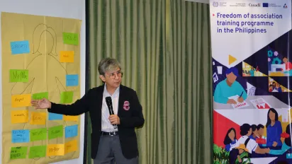 a professor standing and speaking during the training