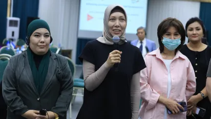 Group of women standing, one with a mic