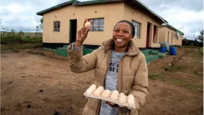 South African woman showing eggs from her business