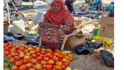 sudanese women with her fruit and vegetable business