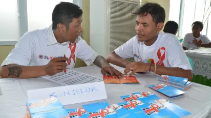several participants in a room with HIV and AIDs brochures on the desks