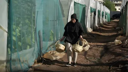 female worker carrying baskets