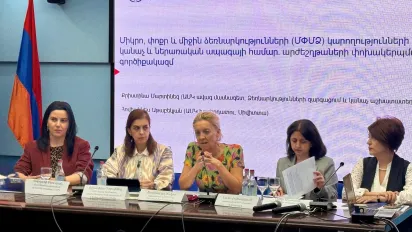 Five women sitting at a table
