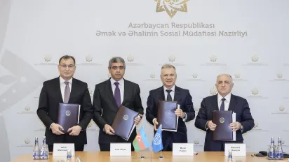 Four men holding folders