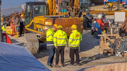 Workers at a construction site with machines
