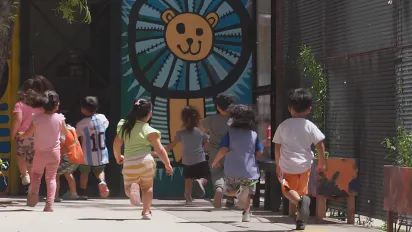 Children run toward the safety of the Early Childhood Space at La Carcova Popular Library, a vibrant sanctuary that reclaims their time from labour to provide a more dignified and peaceful childhood