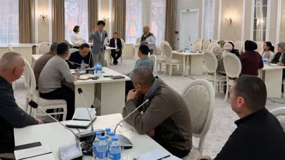 A facilitator engages with participants during a role-play exercise as other employment counsellors observe during training in Fergana region, Uzbekistan
