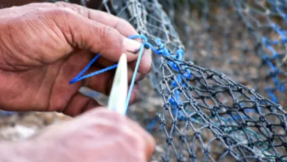 A fisher fixes a cantrang net