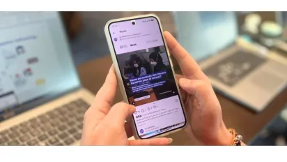 A hand holding a smartphone