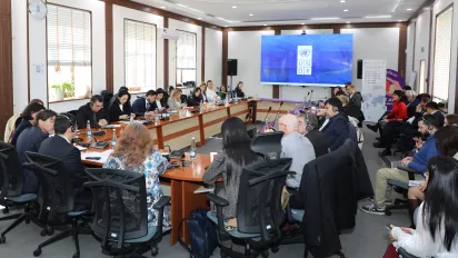 Group of people sitting at an oval table